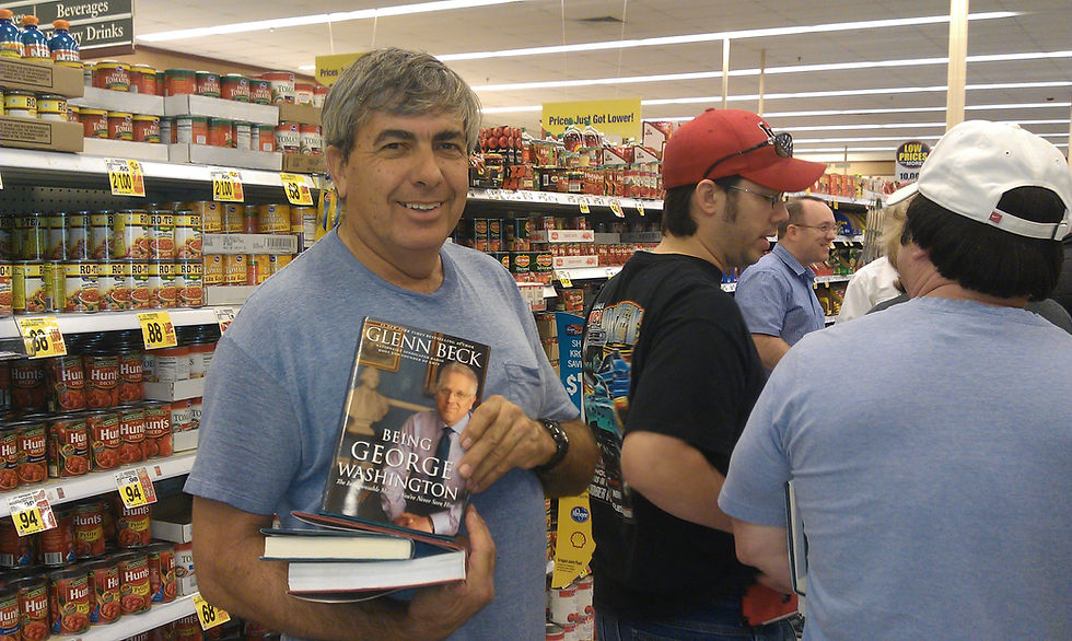 Standing by the tomato aisle, Sybren flashes the book about George Washington while we are in line to ask Glenn Beck to sign it.