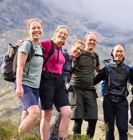 Smiling group on a mountainside