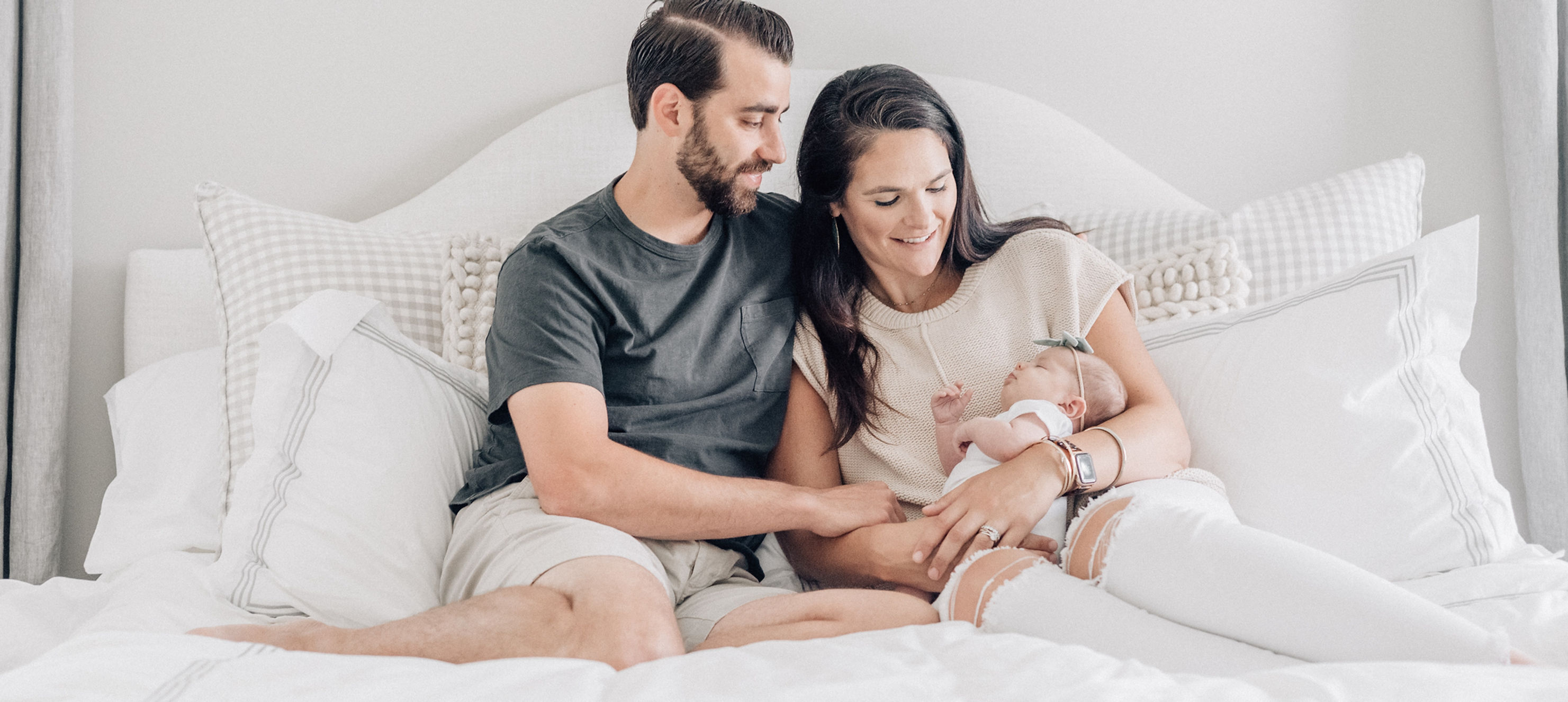 couple on a bed with a baby