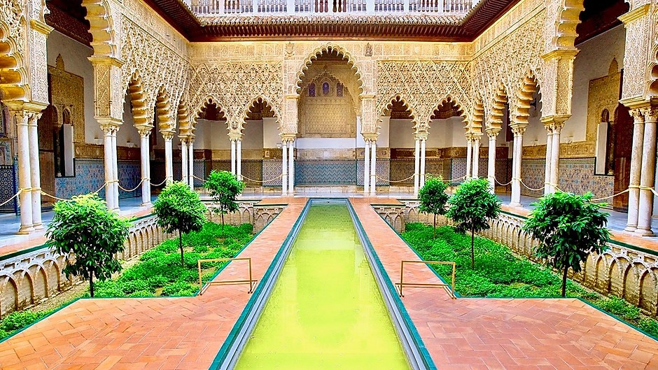 Courtyard of the Maidens with its long reflecting pool in the Alcázar
