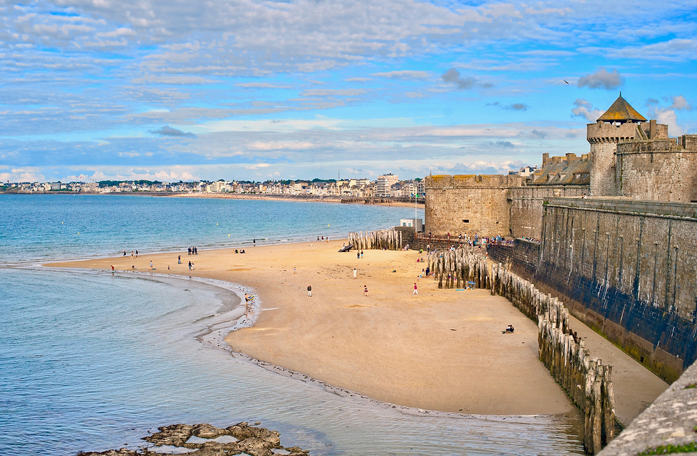 Atlantic beach under the towers of city walls in St Malo