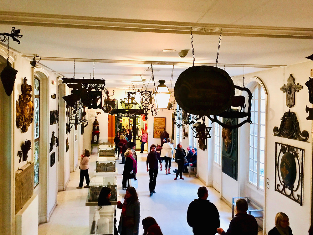 a gallery of the Musee Carnavalet filled with street signs