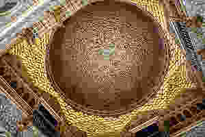 the gold domed ceiling of the Ambassador's Hall in Pedro's Palace in the Alcázar