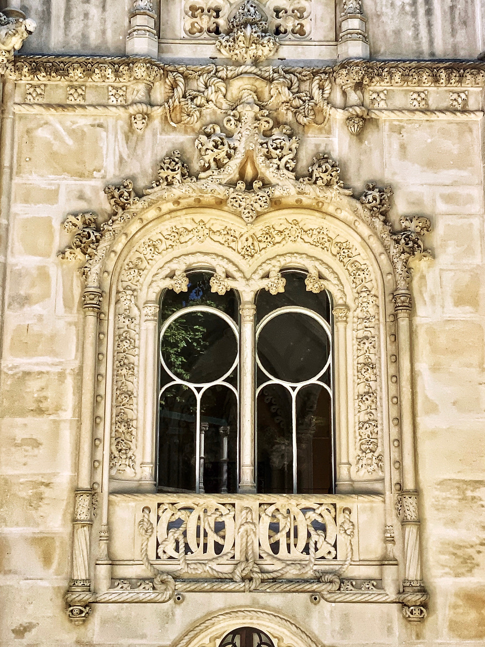 an ornately carved Neo-Manueline style window on the exterior
