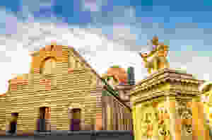 raw facade of the Basilica of San Lorenzo and the Giovanni delle Bande Nere monument