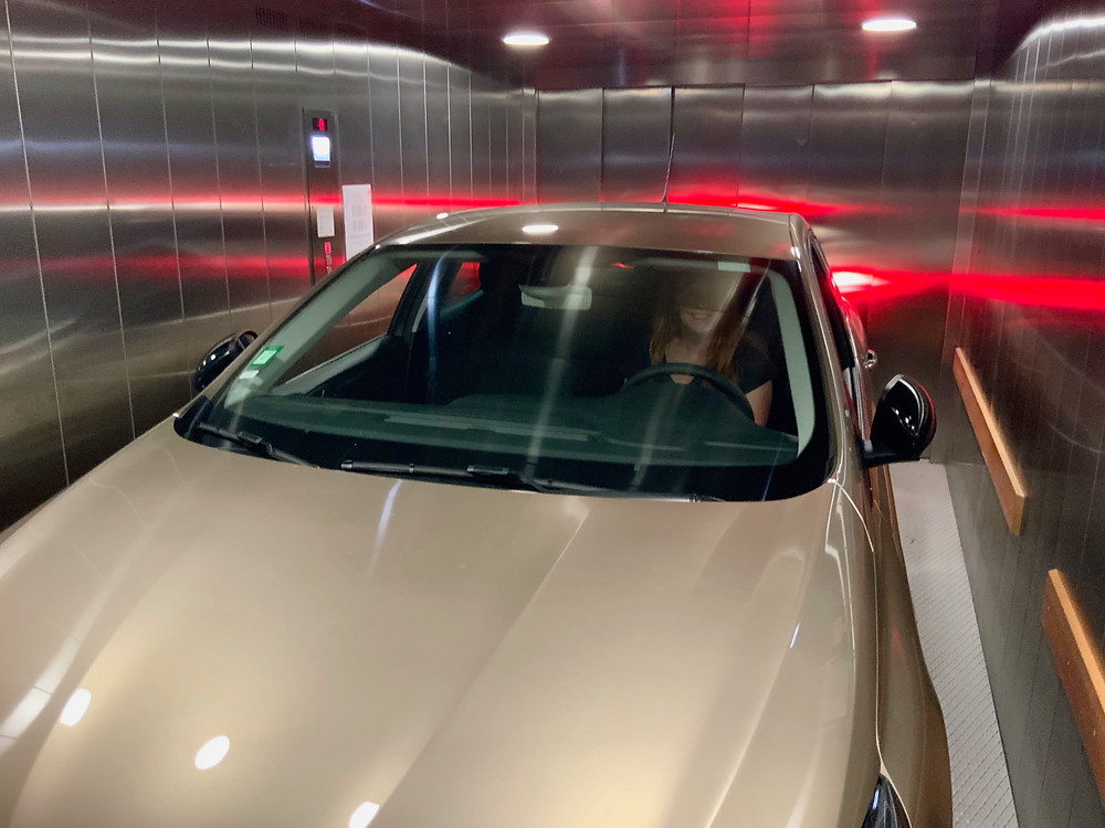 Having wedged my car through a tiny gated entrance, I am now in a tiny car elevator in my tiny car. What could be better?