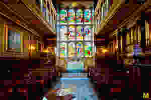 stained glass windows and pews in the chapel of Hatfield House
