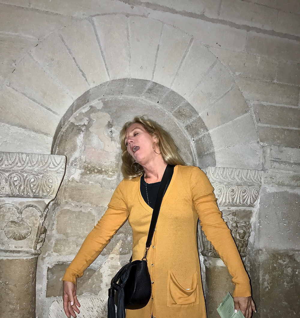 statue posing in an empty niche in the crypt of the Basilica de Saint Denis in Paris