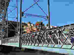 a fearless man about to jump from the Dom Luis I bridge