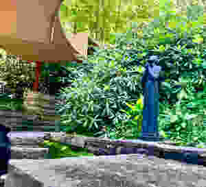 covered passageway leading to the guest cottage with a Richmond Barthé statue, Serena, from 1940