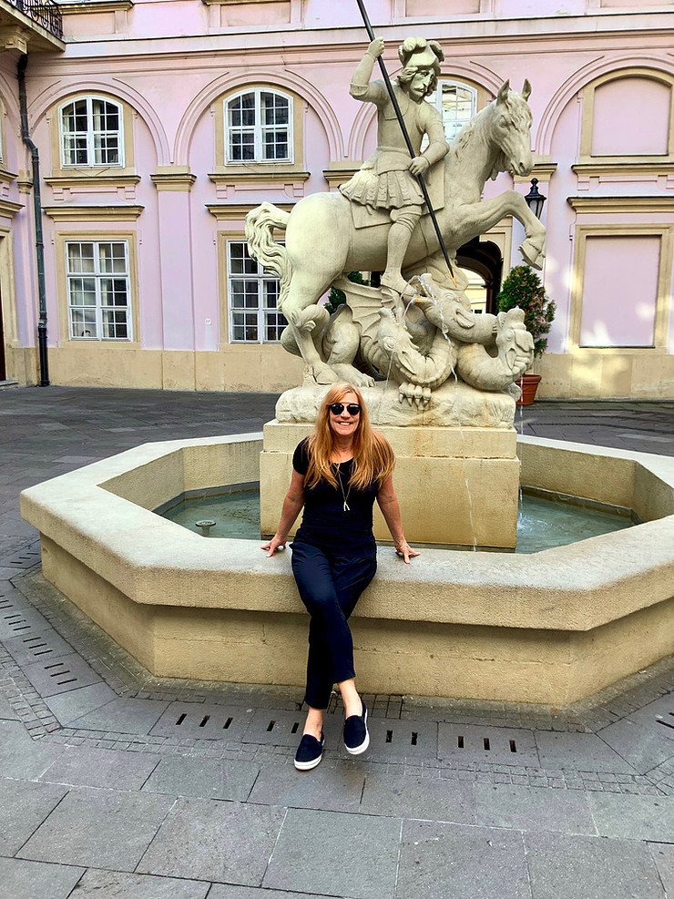 taking a break at the Saint George Fountain in the pretty Primate's Palace courtyard in Bratislava