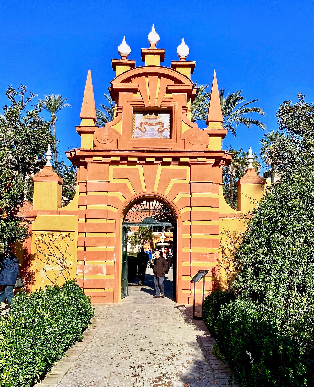 an orange and ochre hued Almohad Tower marking the entrance to the English Garden