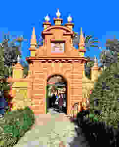 an orange and ochre hued Almohad Tower marking the entrance to the English Garden
