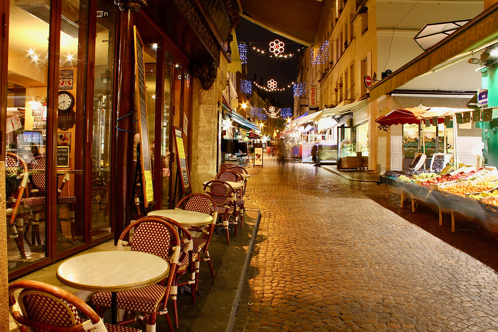 the cobblestones of Rue Mouffetard at night, in Paris' Latin Quarter
