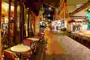 the cobblestones of Rue Mouffetard at night, in Paris' Latin Quarter