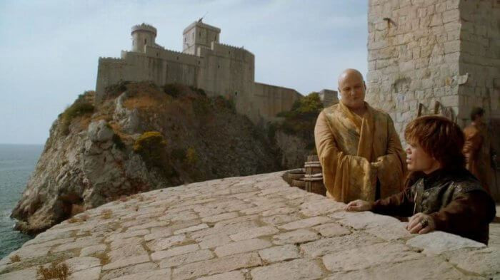 A CGI'd image of Fort Loverijenac in the background, Varys and Tyrion in the foreground at Fort Bokar