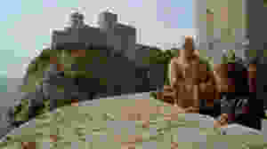 A CGI'd image of Fort Loverijenac in the background, Varys and Tyrion in the foreground at Fort Bokar