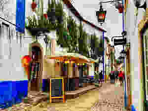 Rue Direita in Obidos Portugal, lined with artisan shops and cute little eateries