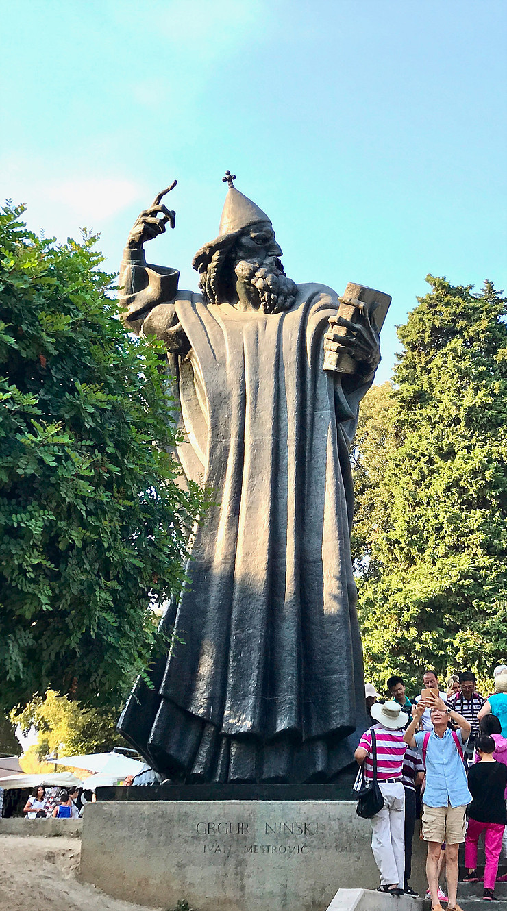 tourists crowded around the lucky toe of Gregory of Nin