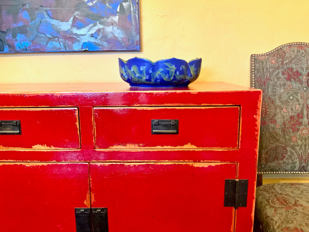 a beautiful arts and crafts bowl that I purchased in the museum shop, on top of my Asian inspired dining room buffet