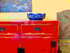 a beautiful arts and crafts bowl that I purchased in the museum shop, on top of my Asian inspired dining room buffet