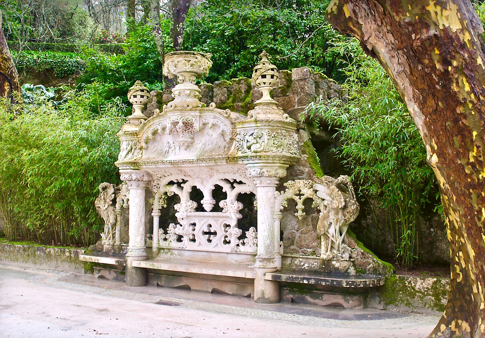 an ornate bench between the palace and the chapel