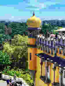 a bulbous tiled yellow onion dome