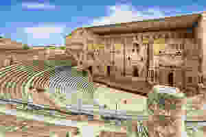 Orange Amphitheater in Provence France, with a statue of Augustus center stage lording over the scene