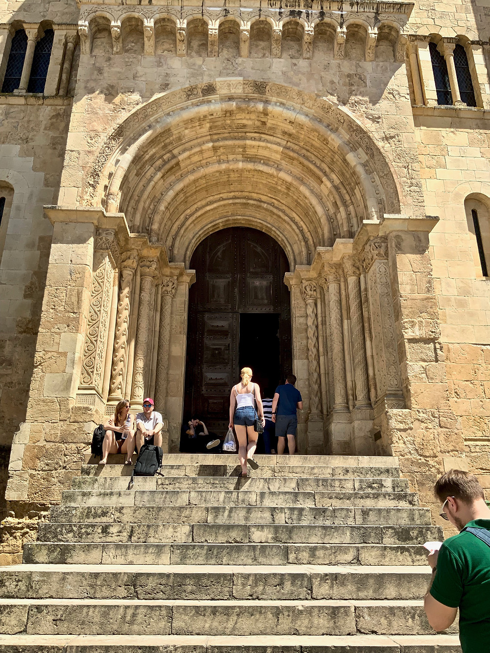 my daughter heading up the steps of Coimbra's Old Cathedral