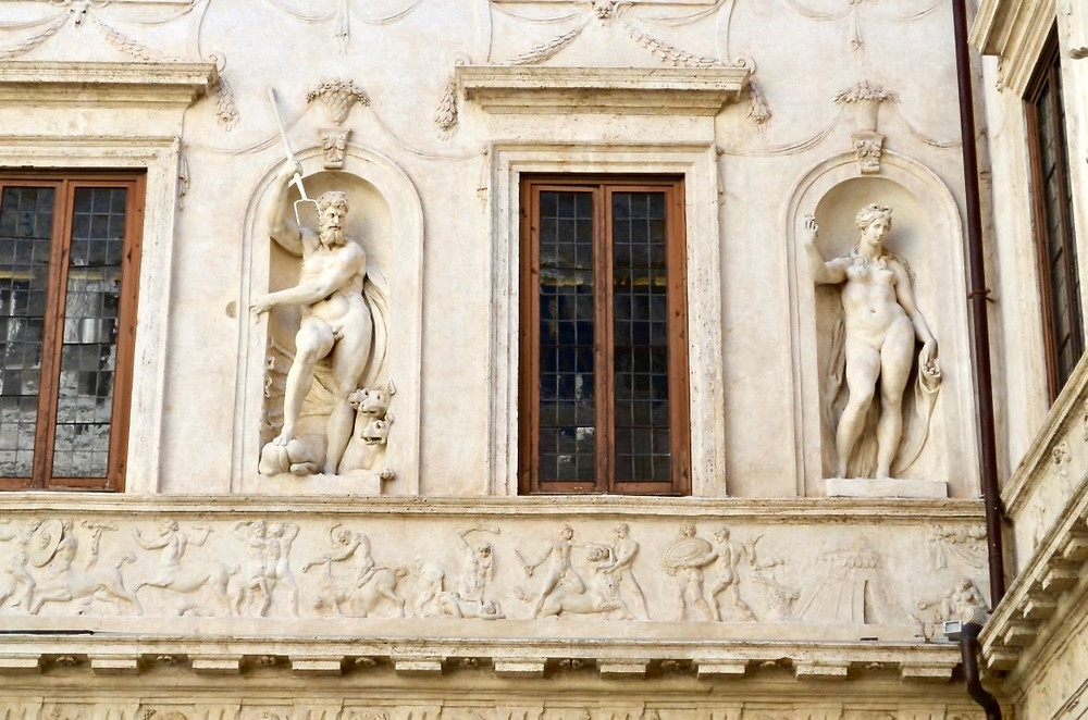 stucco statues of pagan deities Pluto and Persephone decorate walls in the ground floor courtyard