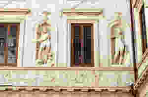 stucco statues of pagan deities Pluto and Persephone decorate walls in the ground floor courtyard