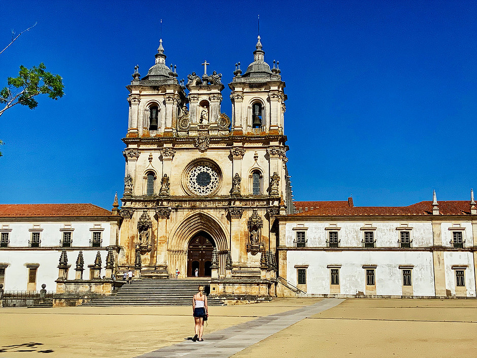 my daughter heading to the entrance of Alcobaca Monastery
