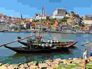 a rabelo boat loaded with caskets of port on the Douro River