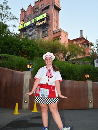 A runner posing in front of the Tower of Terror