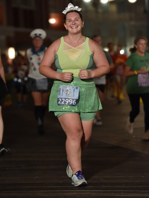A woman running in a Princess Tiana inspired outfit