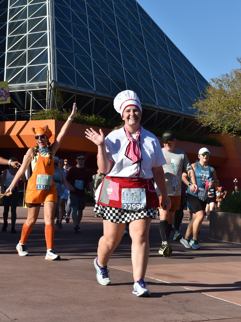 A runner in a Chef Minnie Costume