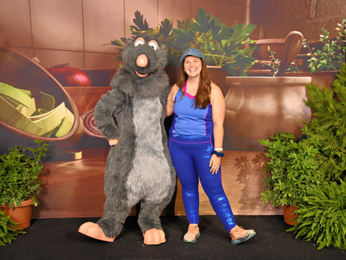 A woman posing with Remy from Disney Pixar's Ratatouille