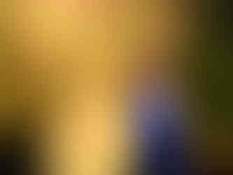 A woman posing with Louis from Disney's Princess and the Frog