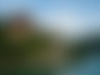 Punakha Dzong, a majestic fortress monastery nestled between two rivers and surrounded by lush green hills in Punakha, Bhutan, under a clear blue sky.