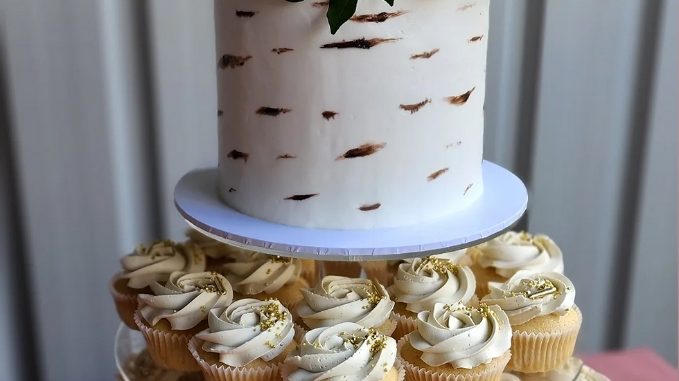 Eye-level view of a rustic wooden cake topper on a layered cake