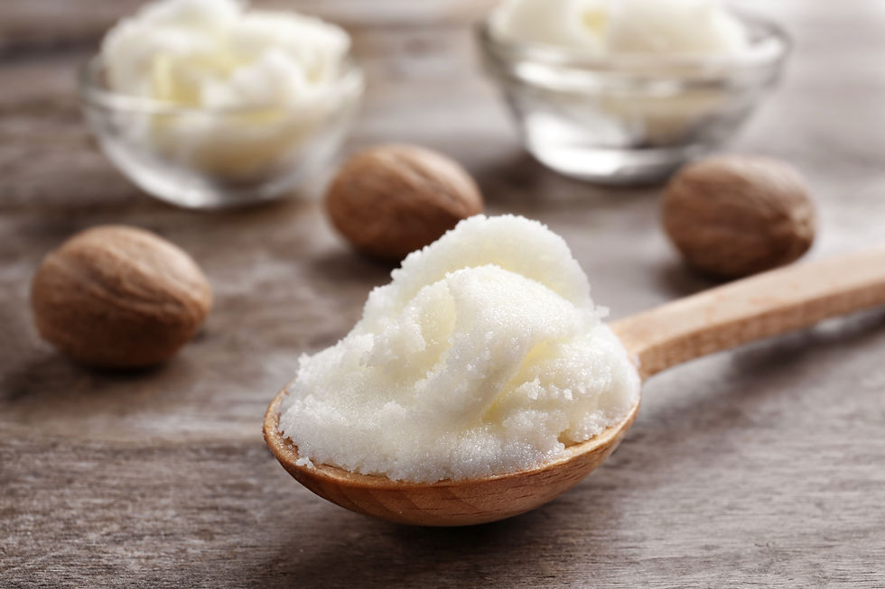 Shea butter in spoon and bowls on wooden