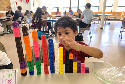 Child in after-school mentoring doing math