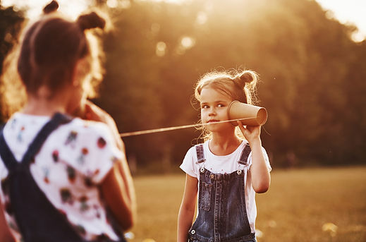 Two female kids stands in the field and 