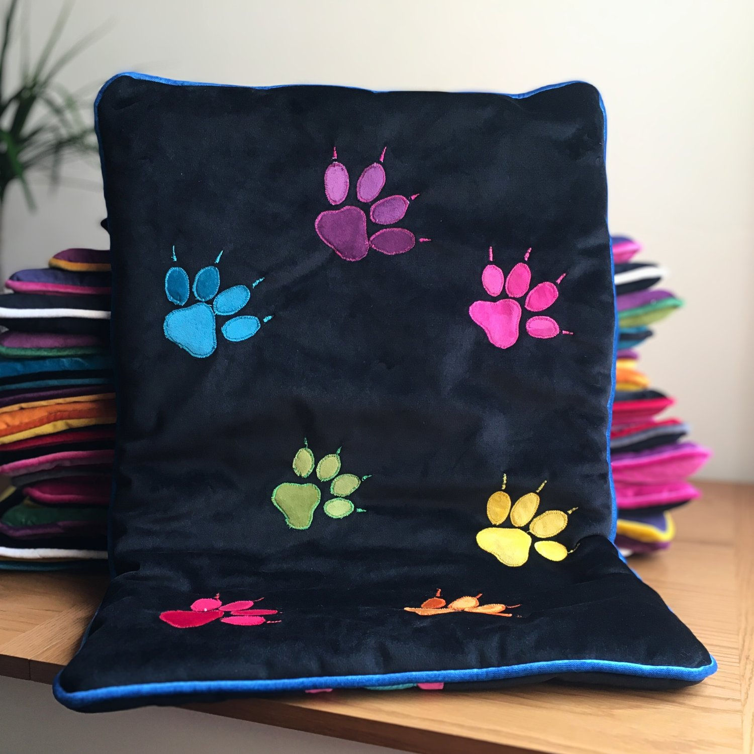 Luxury dog blanket LGBTQ+ rainbow paws design in black eye level view