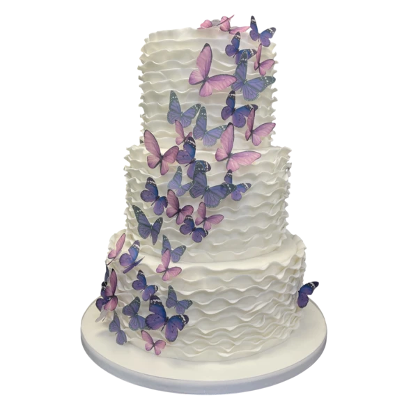 Three-tiered cake with lavender and pink sugar paste butterflies and textured ruffles.