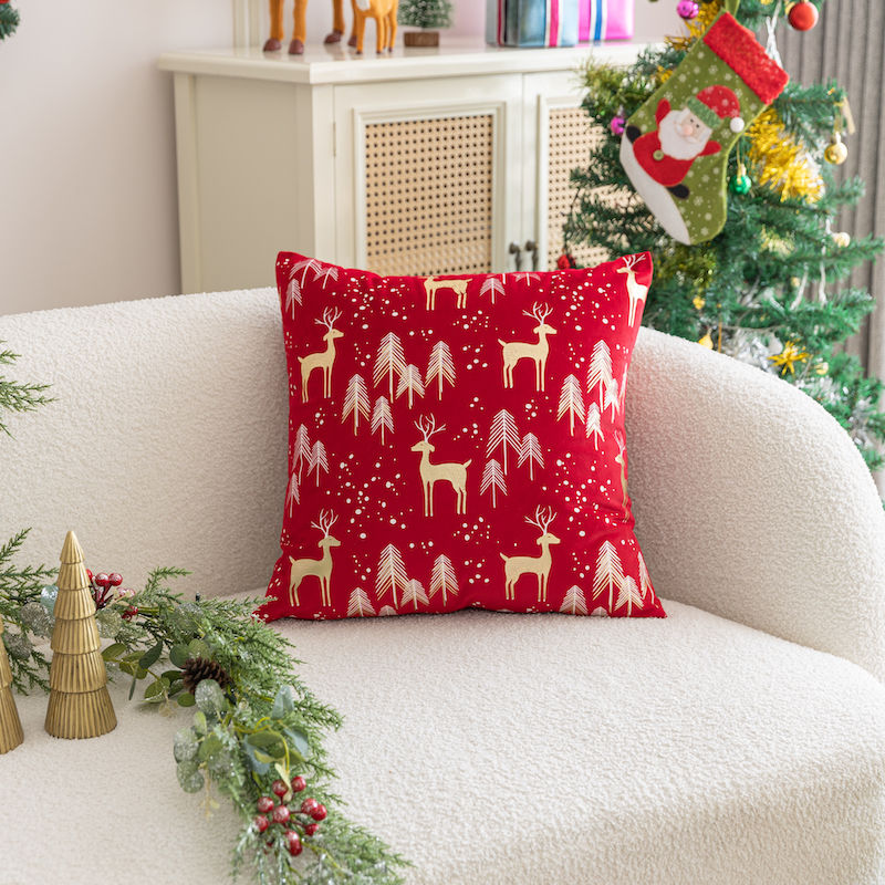 Red Christmas cushion with reindeer and festive pattern design