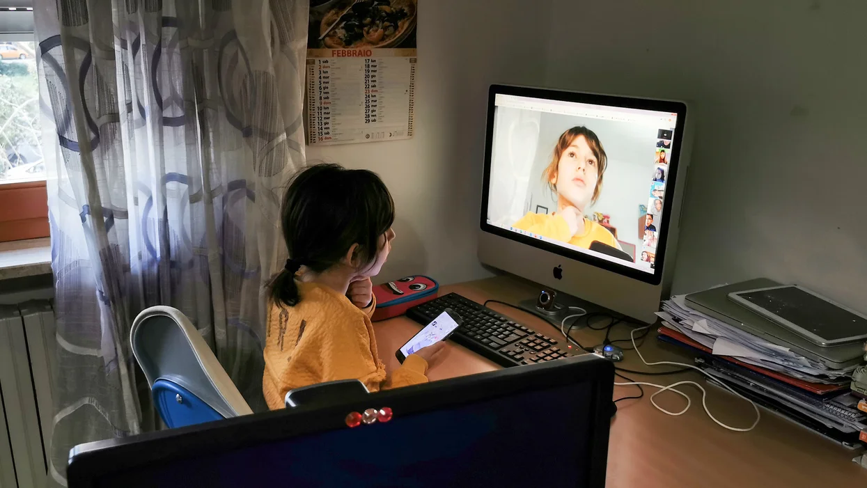 a-girl-sits-at-a-computer.webp