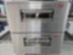 Two stacked stainless conveyor pizza ovens.