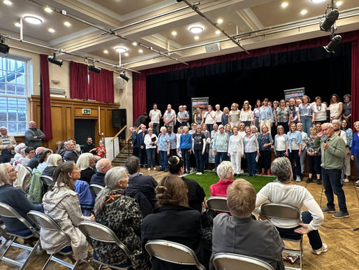 choir singing to an audience in a village hall