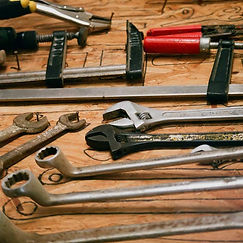 Image of a workbench with a variety of hand-tools on it